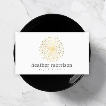 gold dandelion starburst logo on white business card