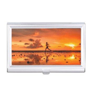man running on beach at sunset business card case