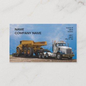 semi truck and trailer hauling a large dumptruck business card